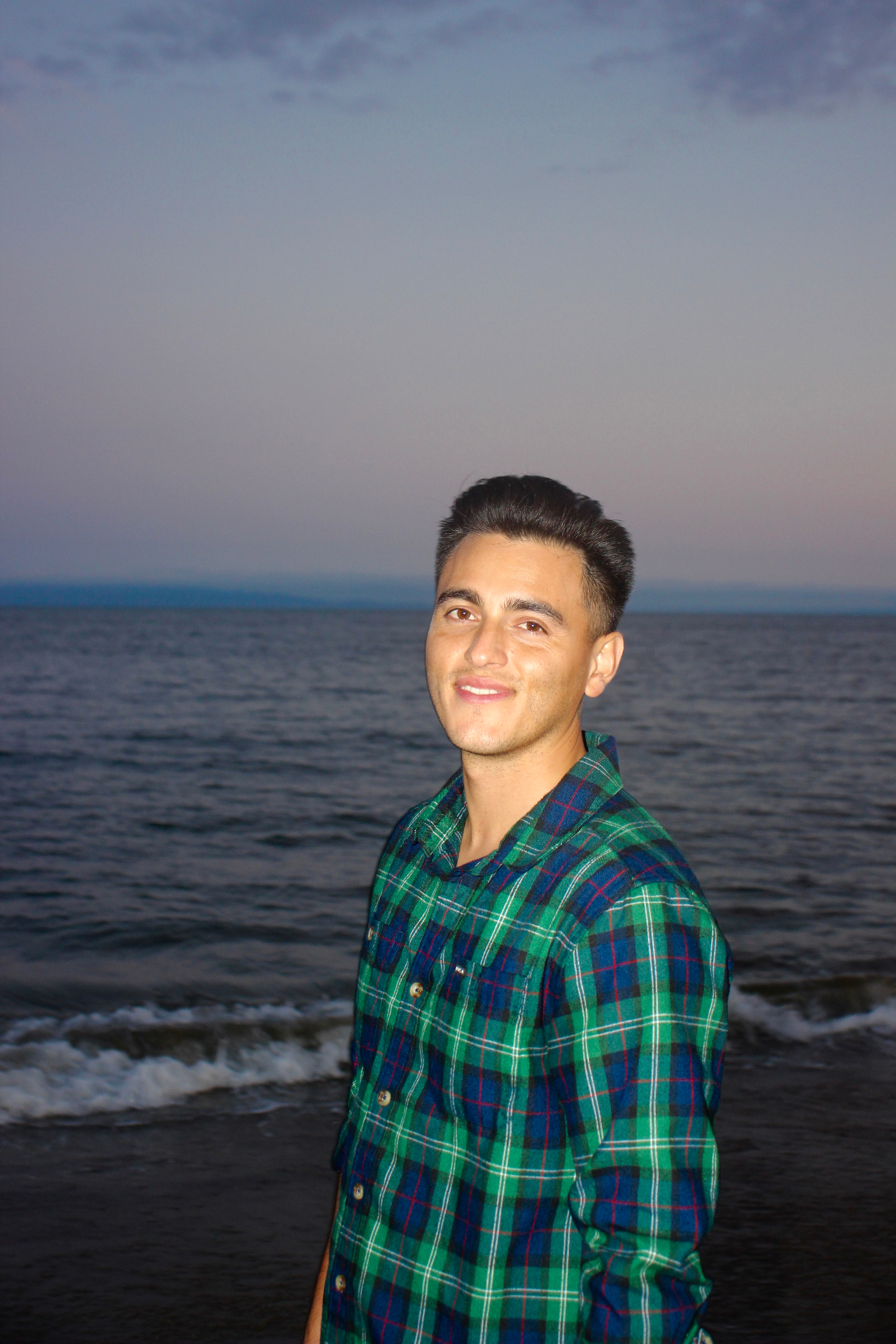 Founder of Breakwater Digital standing by the water at dusk